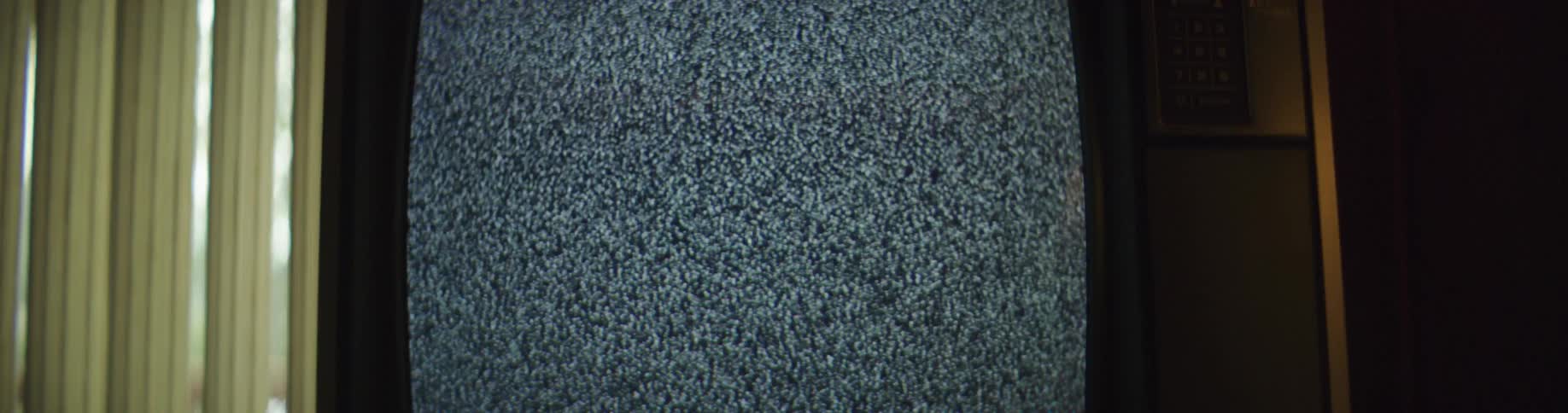 A television broadcasting static suddenly shuts off