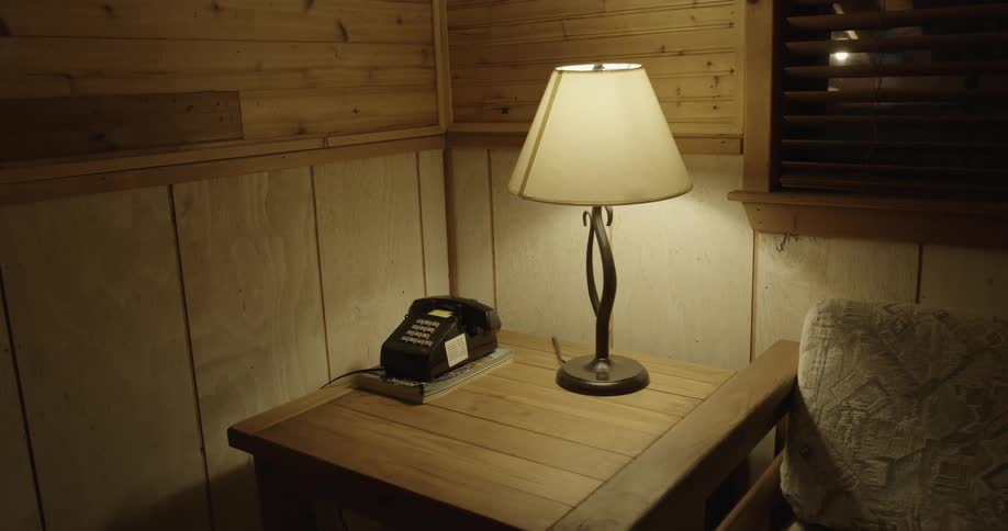 Table lamp brightens living room area near side table and window
