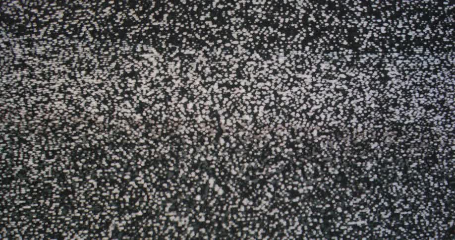 Black and white static on the screen of a vintage television set