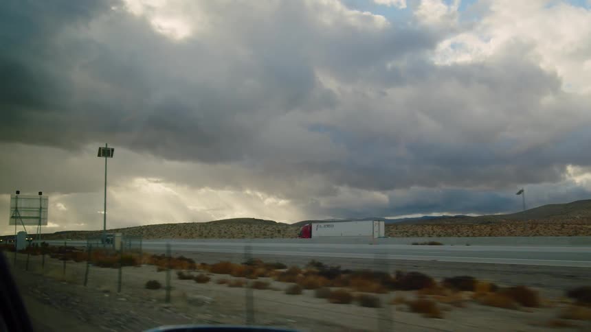 Cars and trucks driving down a highway