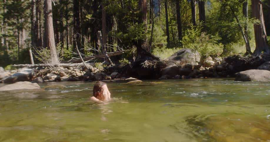 A young boy relaxes in the river