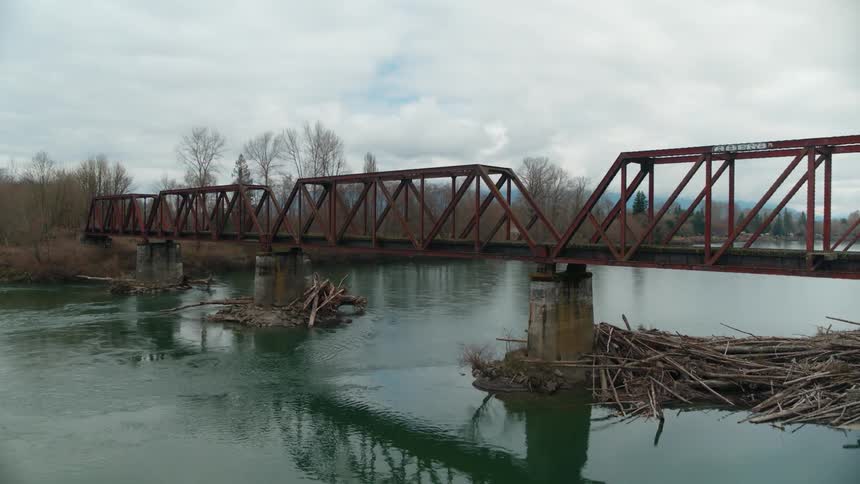 Aerial view of small railroad bridge over a river