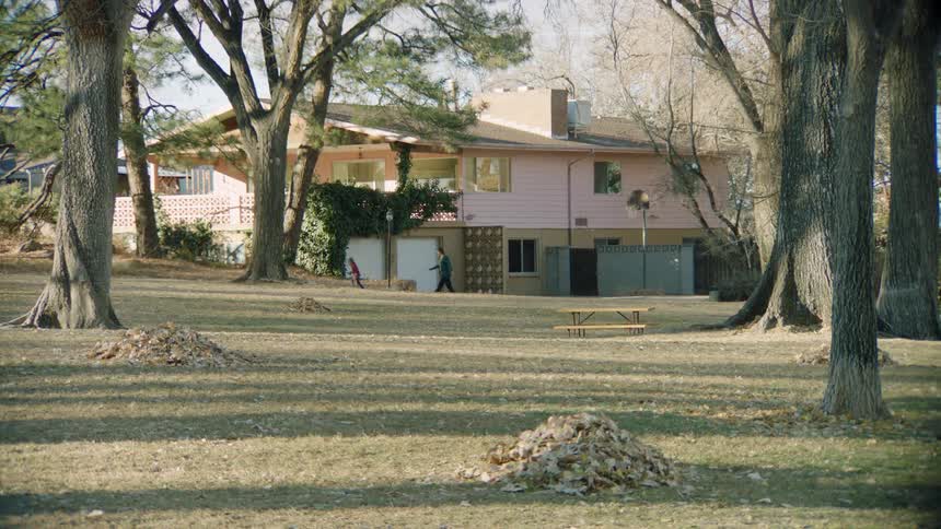 Mother and daughter walk on the big backyard of a house