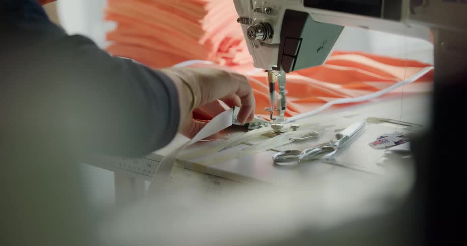 Woman makes face masks with sewing machine