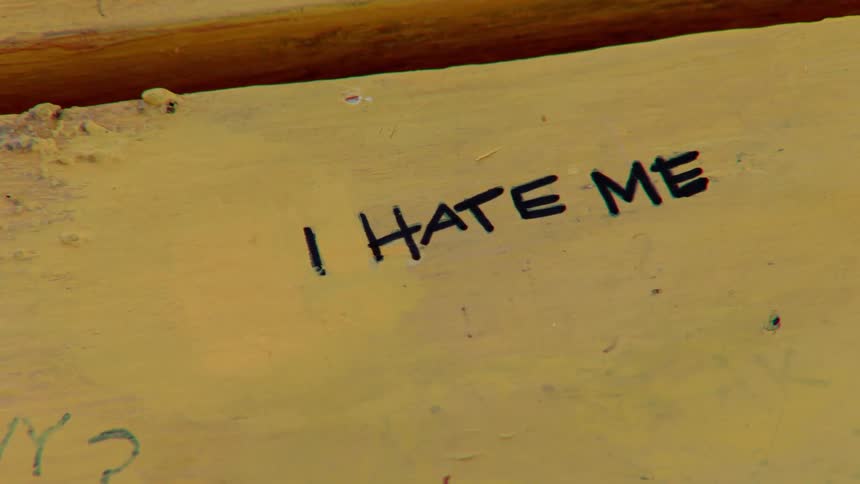 A negative statement is written in marker on a wood board