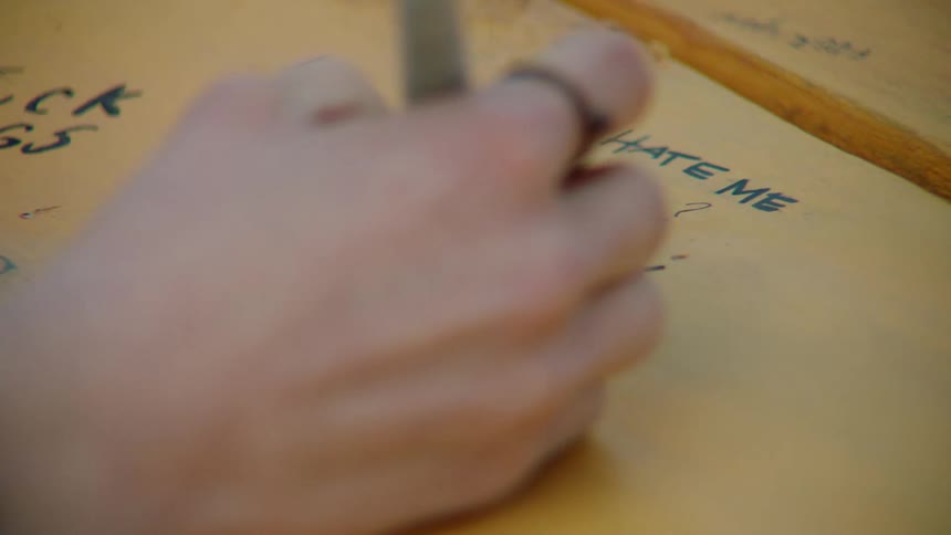 A person writing on a desk