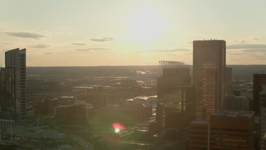 Sun glares across city downtown on slightly misty day