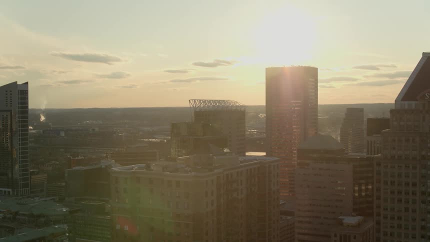 The sun shines against the buildings