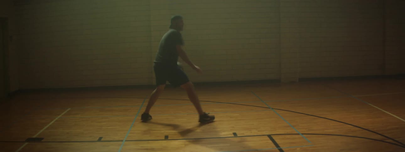 Man dribbles and shoots ball gym
