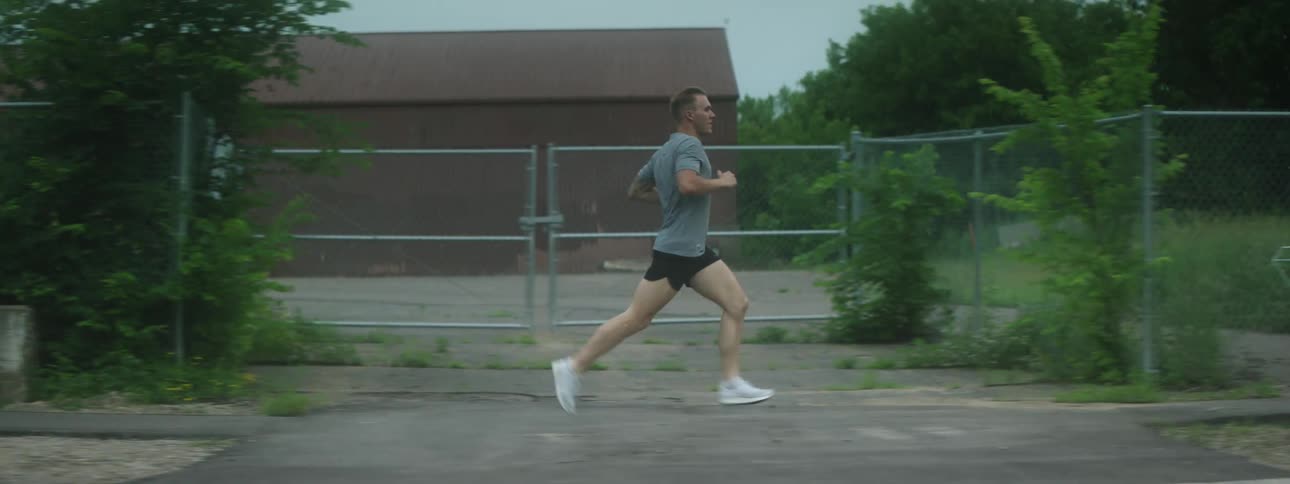 A man runs down a neighborhood street