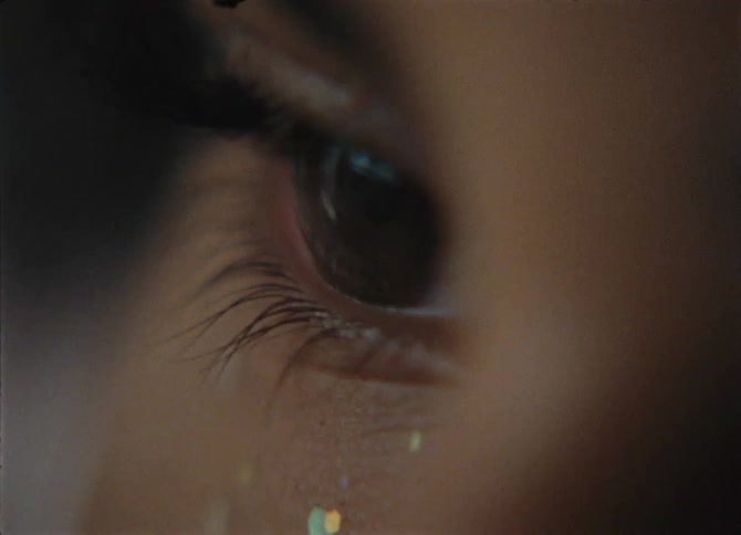A close up of glitter on a teenagers face