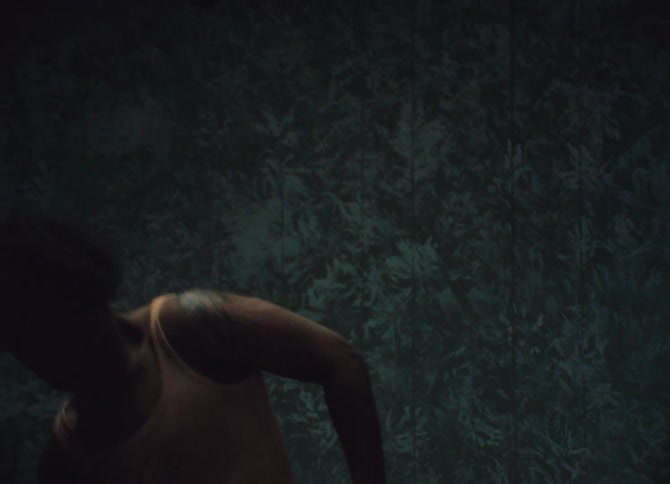 A black man dances in a small room