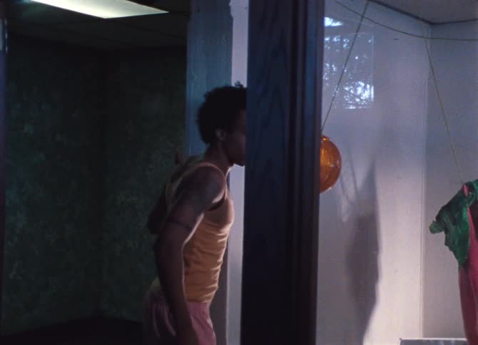 A man dancing and entering into a room