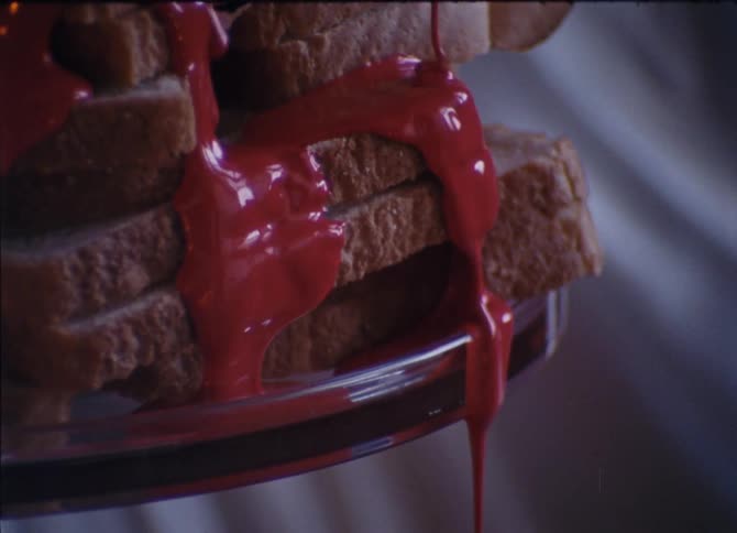 Red liquid pours over the bread