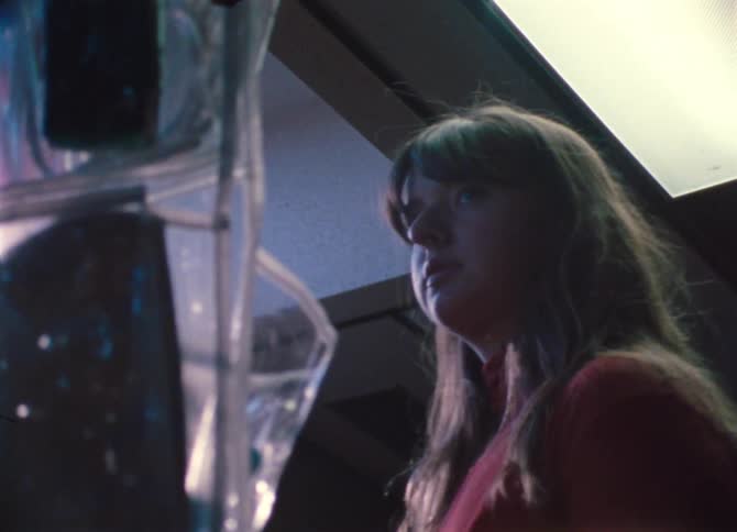 A person turns around in the dark room