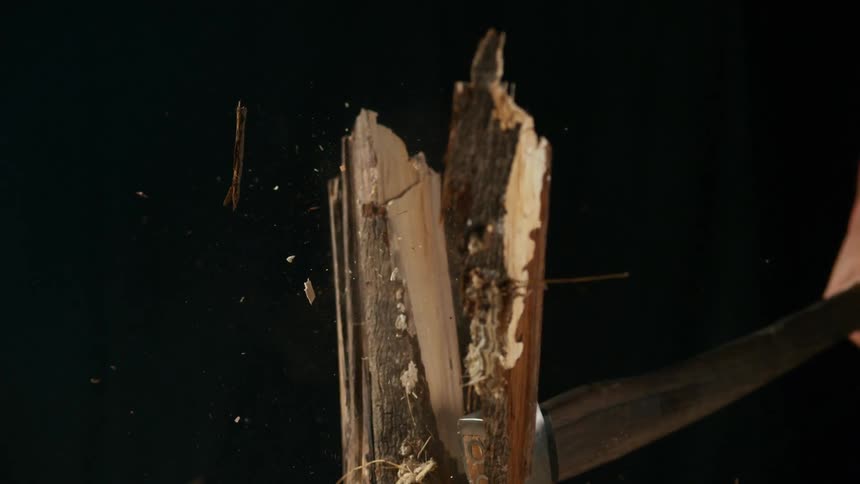 The person chops the wood