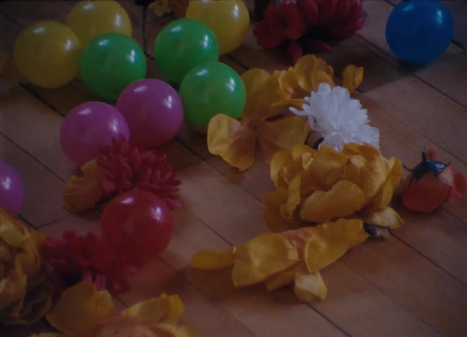Colorful plastic balls and paper flowers on the floor
