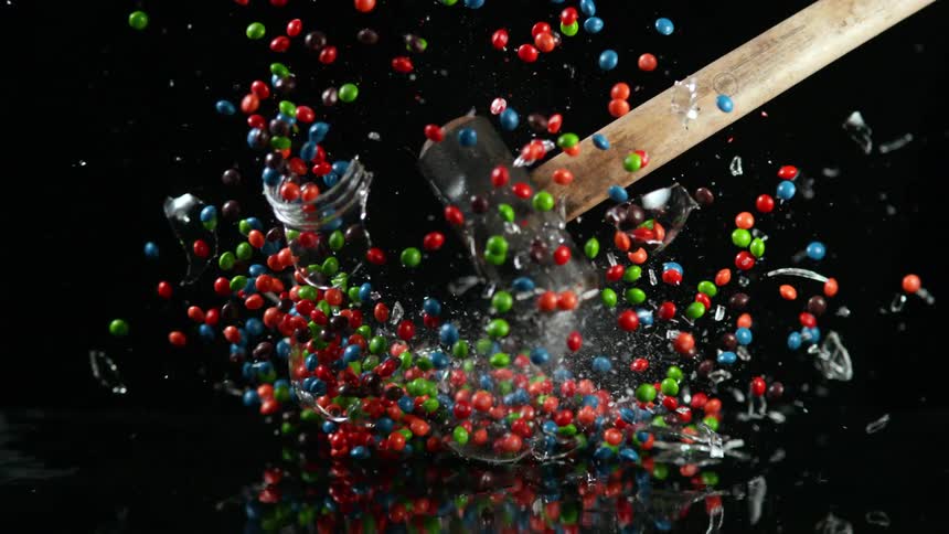A sledgehammer hits a glass car of candy and sends everything flying