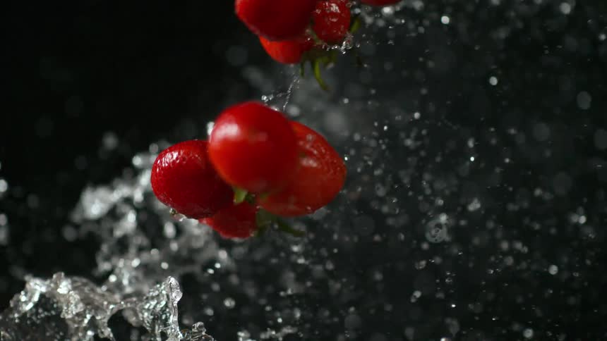 Fruit and water in front of a backdrop in a studio