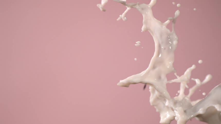 Milk flying across a backdrop in a studio