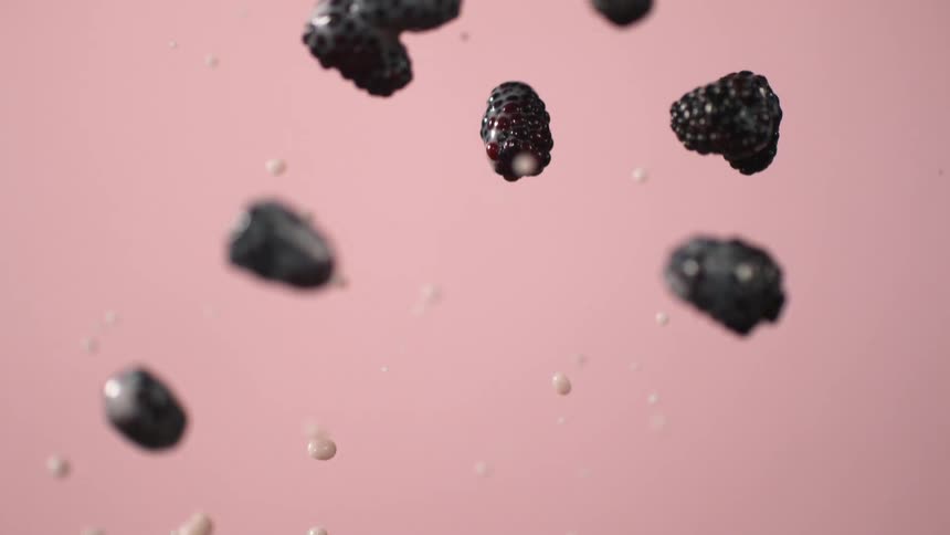 Blackberries splashing in water in slow motion
