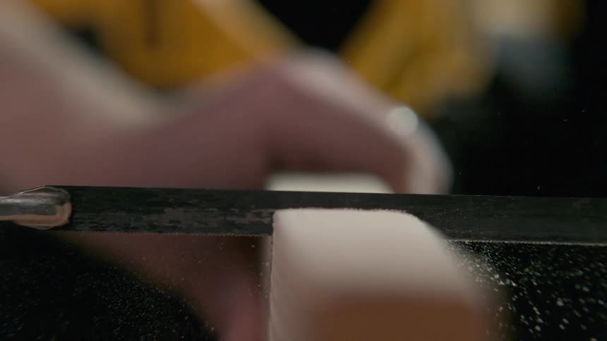 A man saws through wood
