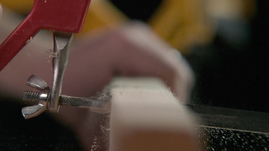 A man saws a piece of wood