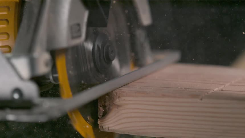 An electric saw cutting through wood