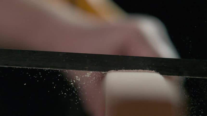 A person saws a piece of wood