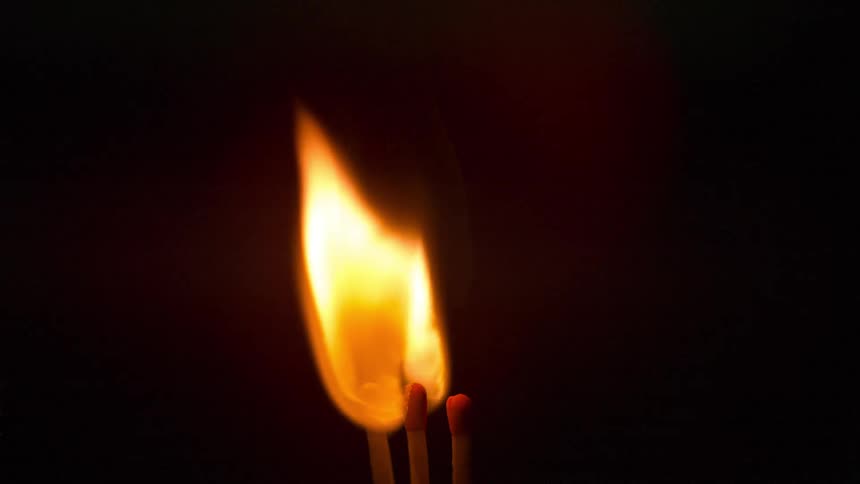 A second wooden match catches from the burning match head beside it