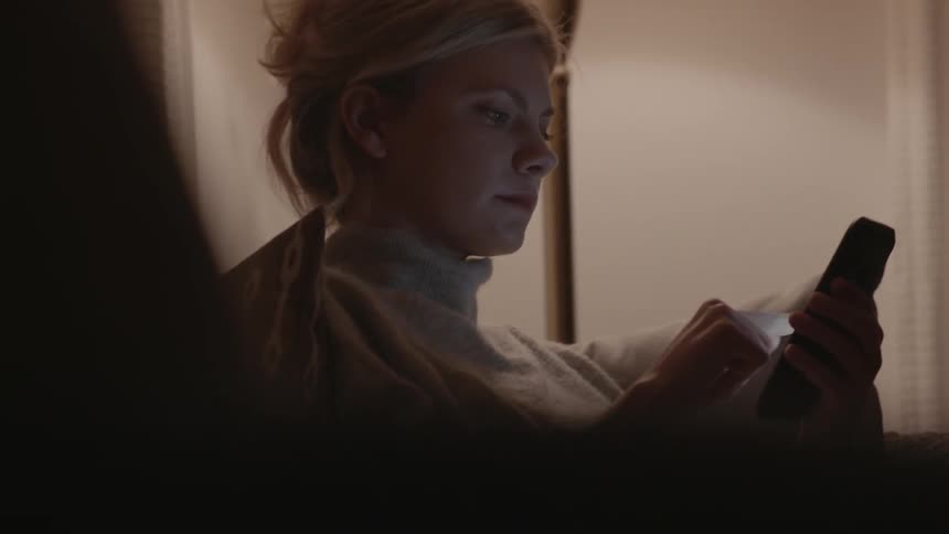 Woman scrolls through website on cell phone