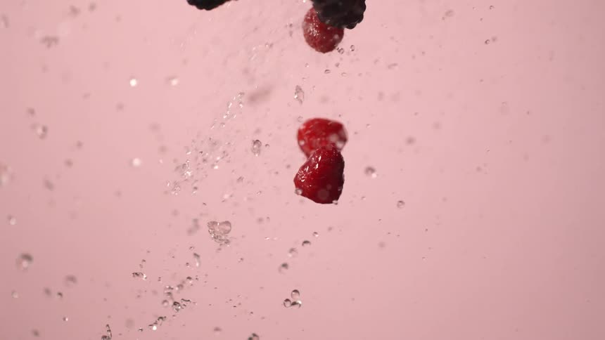 Berries being tossed with water into the air