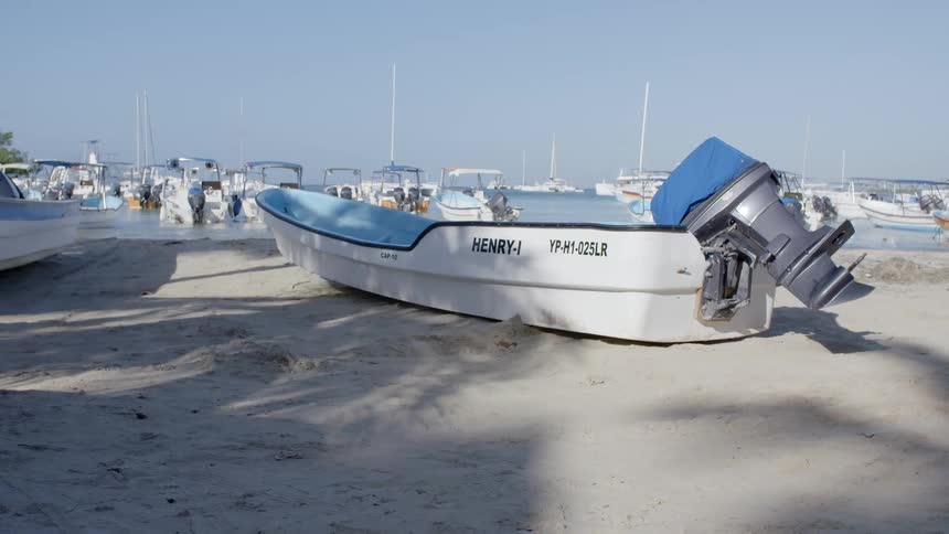 Boats in a marina and on the sand