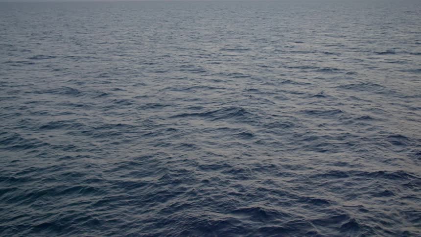 Waves ripple and flow on wide expanse of ocean surface