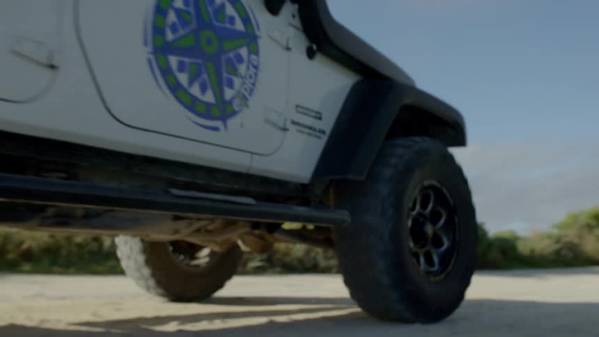 Jeep wranglers lining up on dirt road