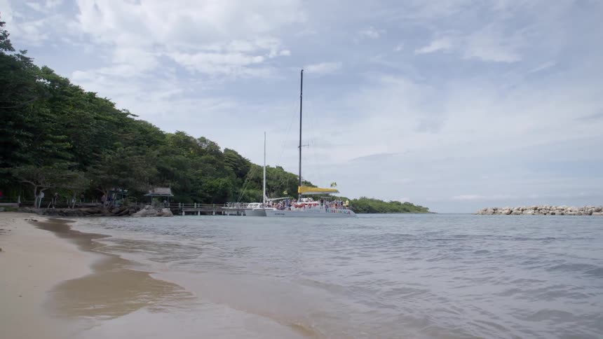 People on a boat parked on the coast