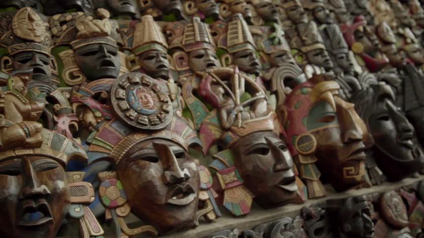 Rows of ornate masks sit on display