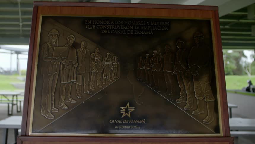 Dedication plaque sits in a pavilion in a park