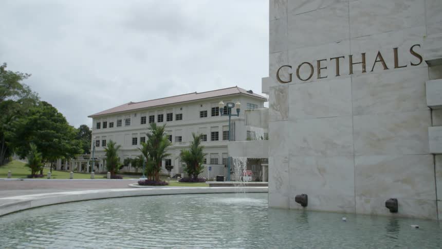 Fountain with large pool surrounds marble sided building