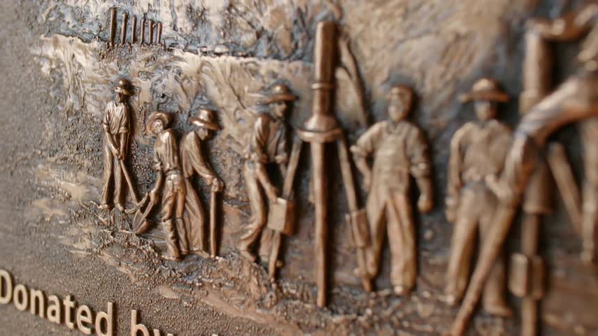 The plaque has people working