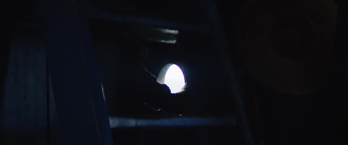 A person looks through a small window