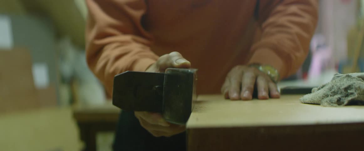 A man sands a table