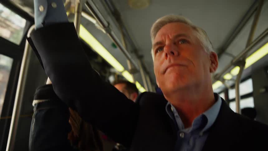 A man stands on a subway