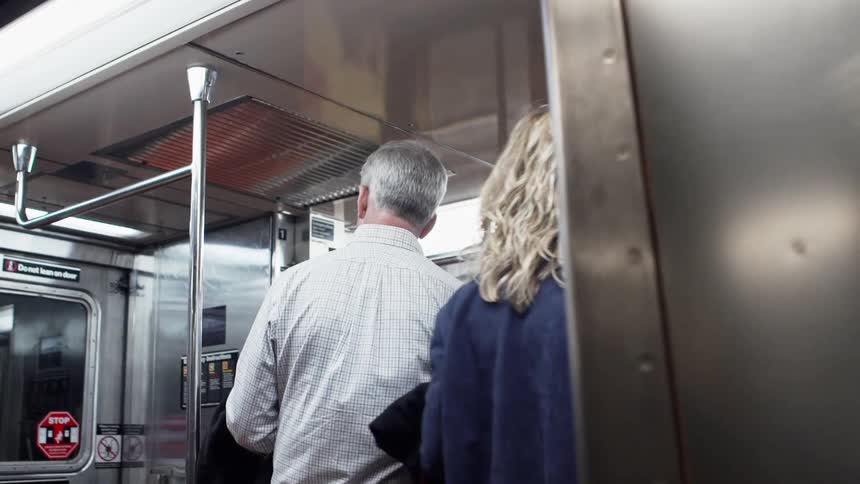 People enter the subway car together