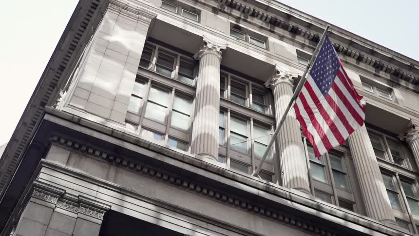 American flag hanging from a government building