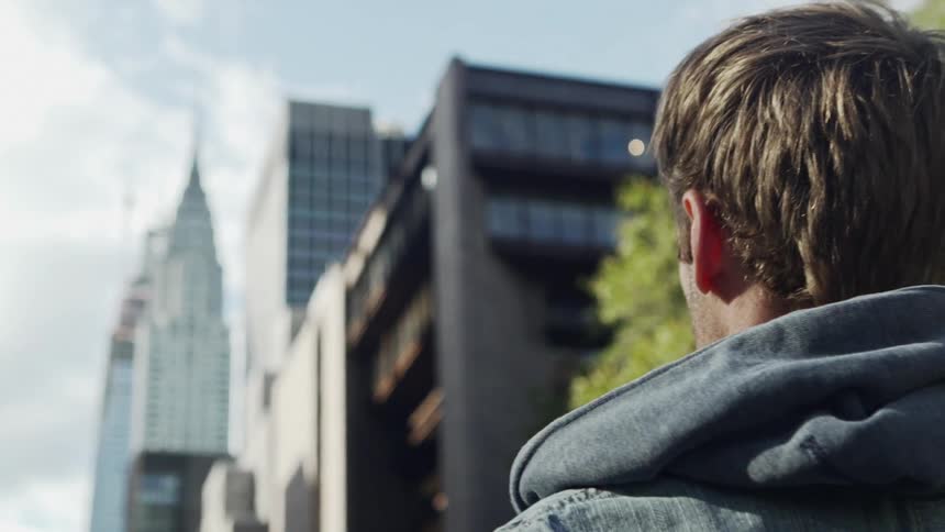 Man photographs downtown skyscrapers with mobile phone