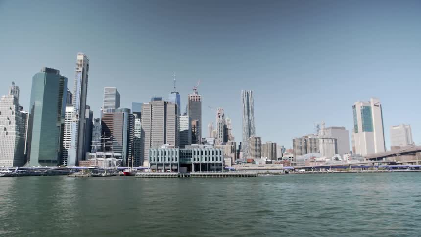 A large downtown area of a city and port sit on the coast of a body of water