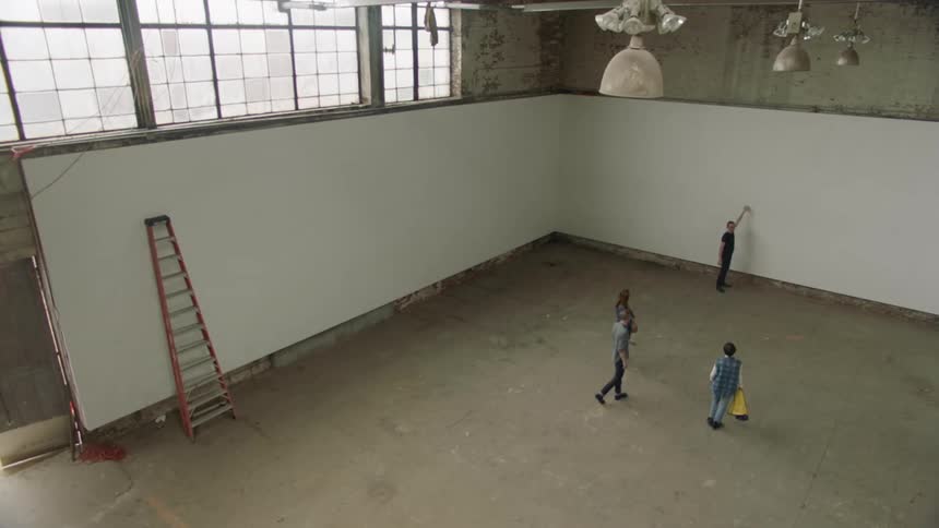 Group consult on room design in large converted warehouse