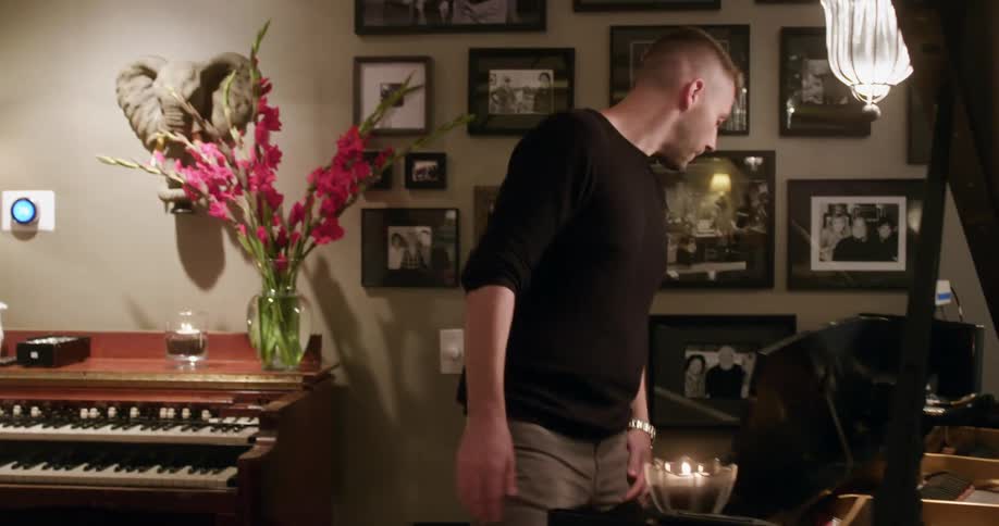 Man walks into room sitting at piano