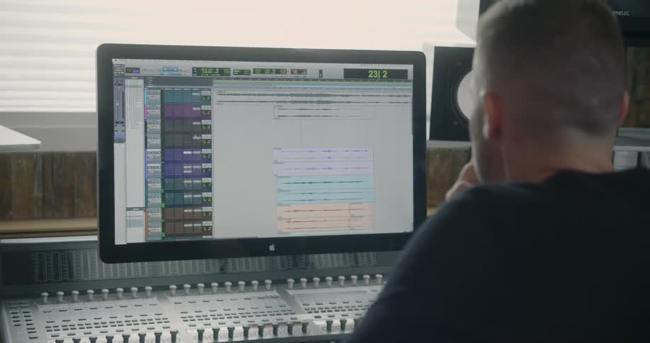 The man looks at the monitor